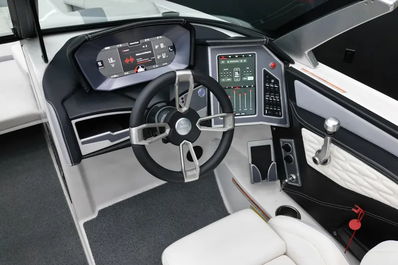 Slide: The Image of 2022 MasterCraft X24 boat dashboard with advanced controls and sleek steering wheel design. - 11