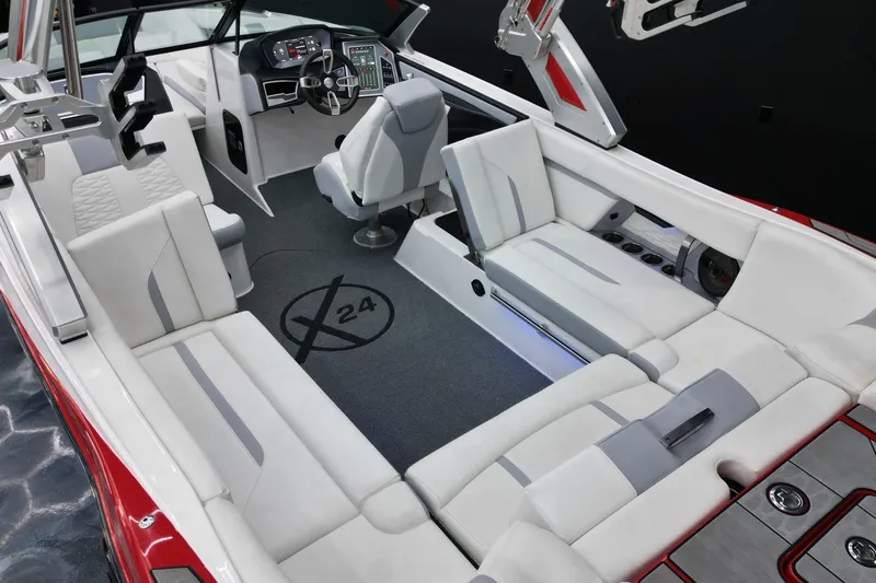 Slide: The Image of 2022 MasterCraft X24 boat interior with white seating and modern dashboard. - 5