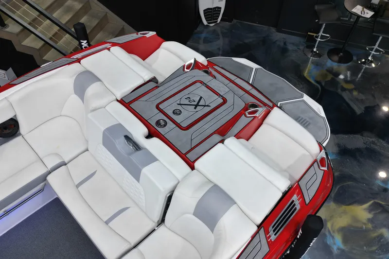 Slide: The Image of 2022 MasterCraft X24 boat interior with red and white seating, viewed from above. - 6