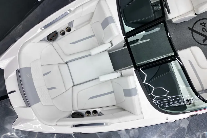 Slide: The Image of 2022 MasterCraft X24 boat interior with white seating and sleek design. - 9