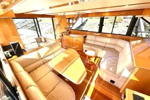 Slide: The Image of Luxurious interior of a 2007 Maritimo 52 yacht with elegant seating and panoramic windows. - 10
