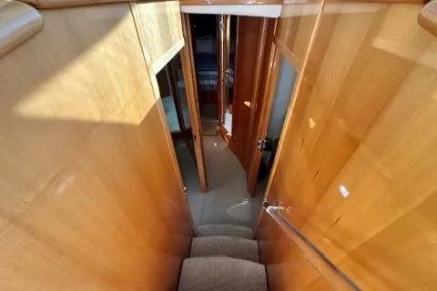 Slide: The Image of Interior view of 2007 Maritimo 52 yacht, featuring wooden stairs and hallway. - 11