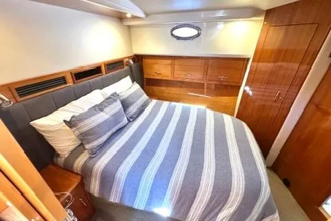 Slide: The Image of Luxurious bedroom interior of 2007 Maritimo 52 yacht with striped bedding. - 12
