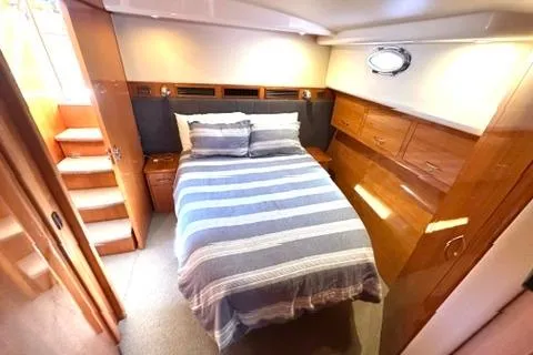 Slide: The Image of Luxurious bedroom interior of 2007 Maritimo 52 yacht with striped bedding. - 14