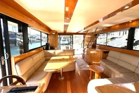 Slide: The Image of Luxurious interior of a 2007 Maritimo 52 yacht with elegant wood finishes and spacious seating. - 19