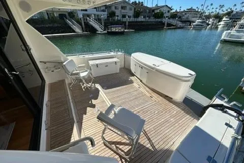 Slide: The Image of 2007 Maritimo 52 yacht deck with seating, overlooking serene waterfront and docked boats. - 22
