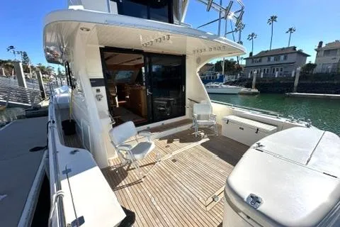 Slide: The Image of 2007 Maritimo 52 yacht with spacious deck, docked in a sunny marina setting. - 23