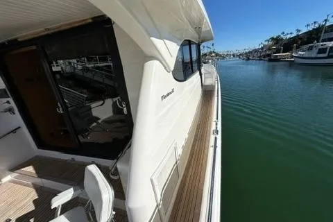 Slide: The Image of 2007 Maritimo 52 yacht docked by a serene waterfront. - 25