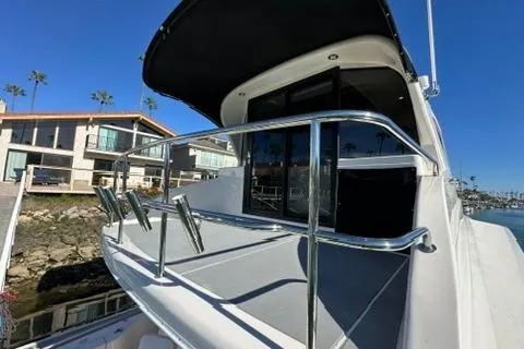 Slide: The Image of 2007 Maritimo 52 yacht with sleek design, docked near waterfront homes. - 26