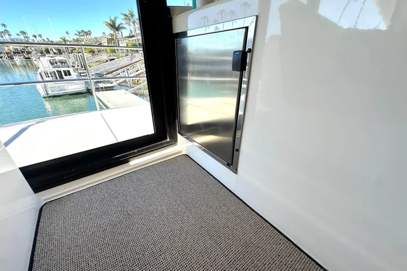 Slide: The Image of Interior view of a 2007 Maritimo 52 yacht, featuring a stainless steel door and marina backdrop. - 37