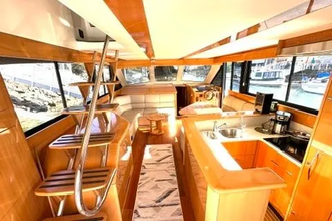 Slide: The Image of Luxurious interior of a 2007 Maritimo 52 yacht with modern kitchen and seating area. - 4