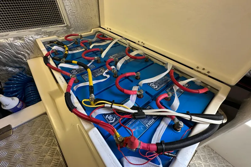 Slide: The Image of Battery compartment of a 2007 Maritimo 52 yacht with connected cables. - 47