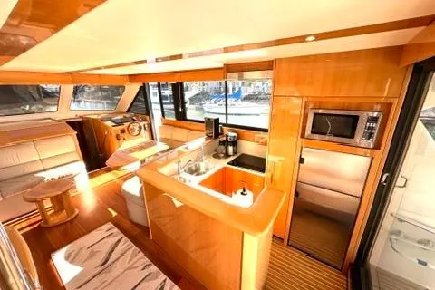 Slide: The Image of Luxurious interior of a 2007 Maritimo 52 yacht featuring a modern kitchen and seating area. - 6