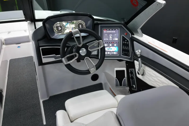 Slide: The Image of 2023 MasterCraft X24 boat cockpit with modern steering and digital dashboard. - 10