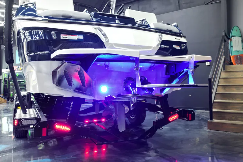 Slide: The Image of 2023 MasterCraft X24 boat with illuminated underwater lights on a trailer. - 11