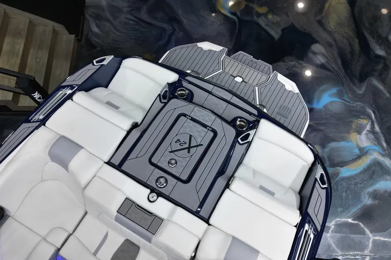 Slide: The Image of 2023 MasterCraft X24 boat interior with sleek white seating and modern design. - 13