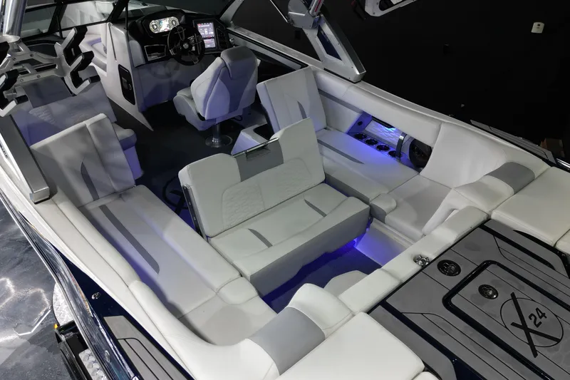 Slide: The Image of 2023 MasterCraft X24 boat interior with luxurious seating and modern dashboard. - 16