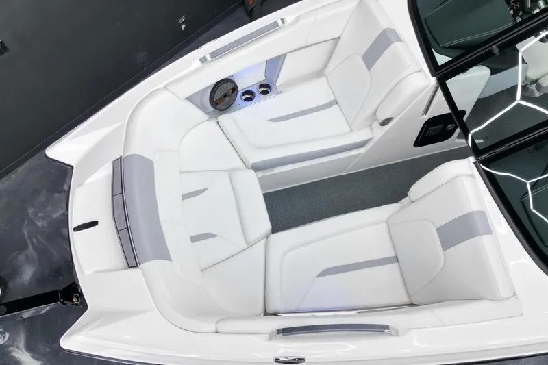 Slide: The Image of 2023 MasterCraft X24 boat interior with white seating and cup holders. - 4