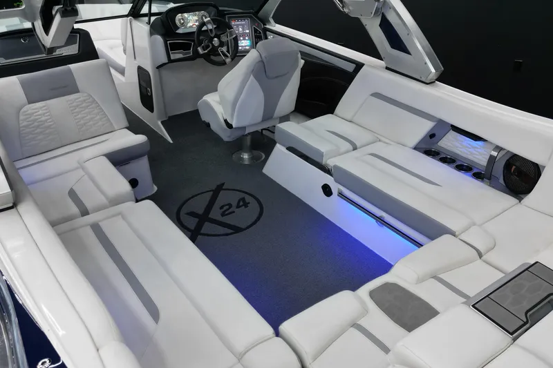 Slide: The Image of 2023 MasterCraft X24 boat interior with luxurious seating and modern dashboard design. - 5