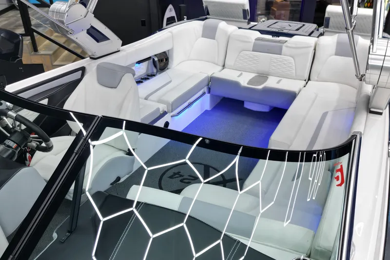 Slide: The Image of 2023 MasterCraft X24 boat interior with luxurious white seating and modern design. - 6