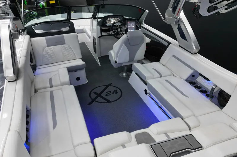 Slide: The Image of 2023 MasterCraft X24 boat interior with luxurious seating and modern dashboard. - 8