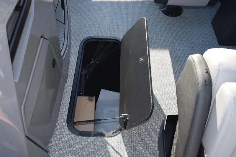 Slide: The Image of Open storage compartment on Evotti 723QL boat, 2026 model, with patterned flooring. - 16