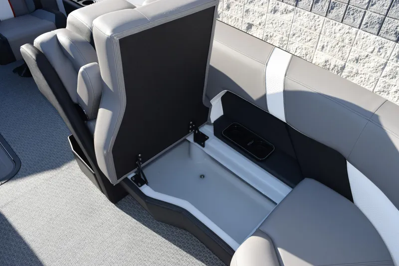 Slide: The Image of Evotti 721CS 2026 boat interior with open storage compartment and gray seating. - 22