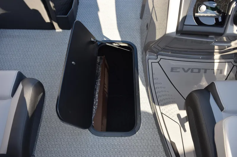 Slide: The Image of 2026 Evotti 721CS boat interior with open storage compartment and seating. - 23