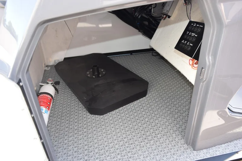Slide: The Image of Interior of 2026 Evotti 721CS boat storage compartment with fire extinguisher and control panel. - 26