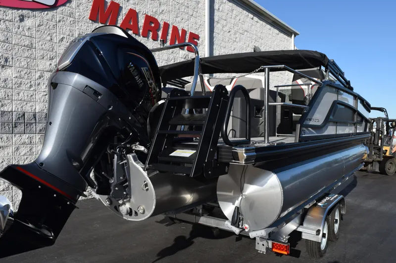 Slide: The Image of 2026 Evotti 721CS pontoon boat with powerful outboard motor, parked at a marine dealership. - 4