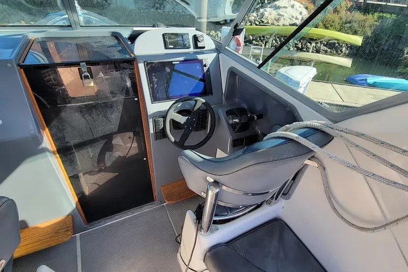 Slide: The Image of Cockpit of 2000 Protector 28 Targa boat with steering wheel and navigation equipment. - 11