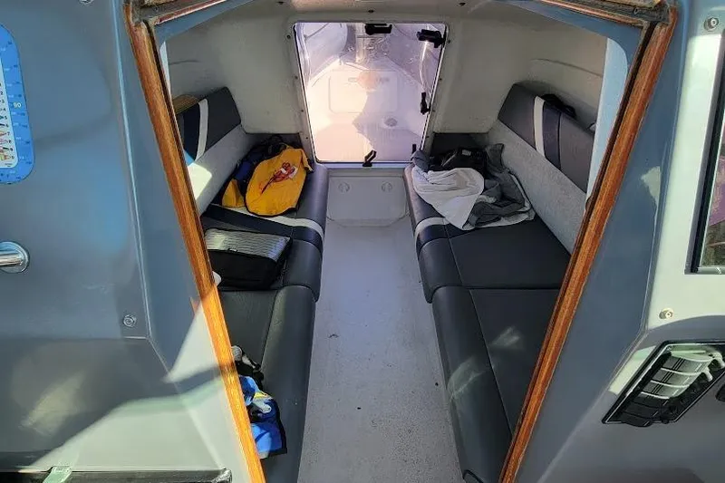Slide: The Image of Interior cabin of a 2000 Protector 28 Targa boat with seating and storage. - 13