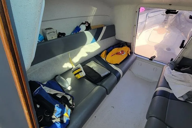 Slide: The Image of Interior of a 2000 Protector 28 Targa boat with seating and gear. - 14