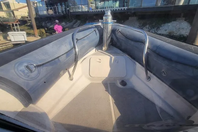 Slide: The Image of Bow view of a 2000 Protector 28 Targa boat docked near a waterfront. - 18