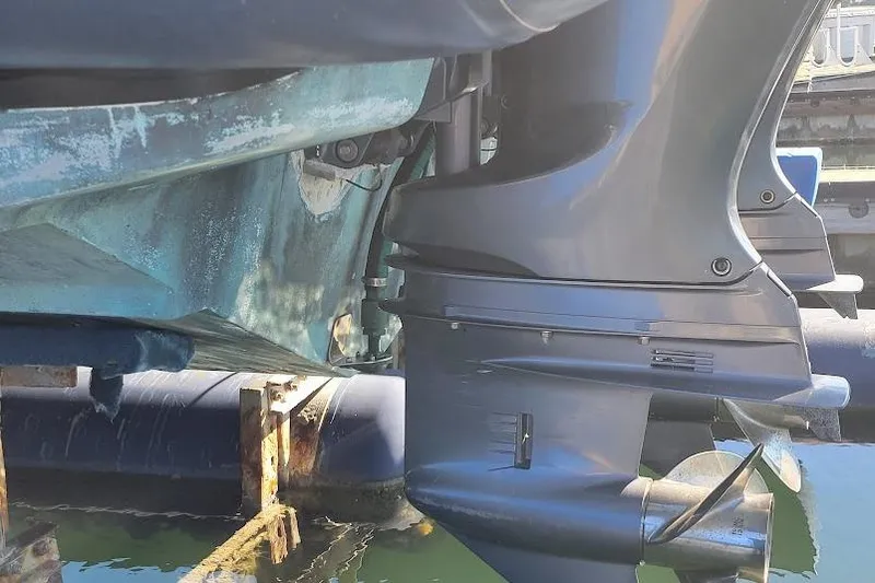 Slide: The Image of Close-up of a 2000 Protector 28 Targa boat's outboard motor in a dock setting. - 6