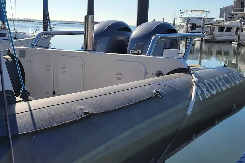 Slide: The Image of 2000 Protector 28 Targa boat with dual 150 horsepower engines docked at marina. - 7