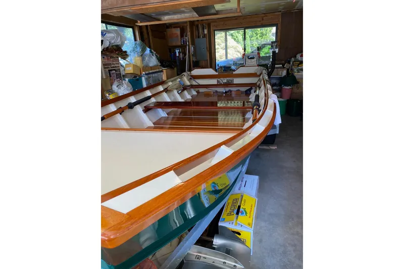 Slide: The Image of Custom 1996 Don boat in a garage, surrounded by various storage items. - 11