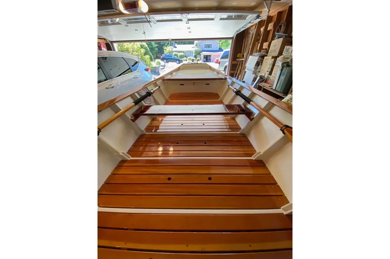 Slide: The Image of Wooden interior of a 1996 Custom Don boat in a garage setting. - 14
