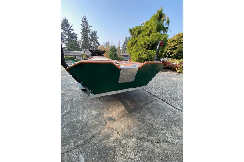 Slide: The Image of Custom 1996 Don boat on driveway, surrounded by trees and greenery. - 19