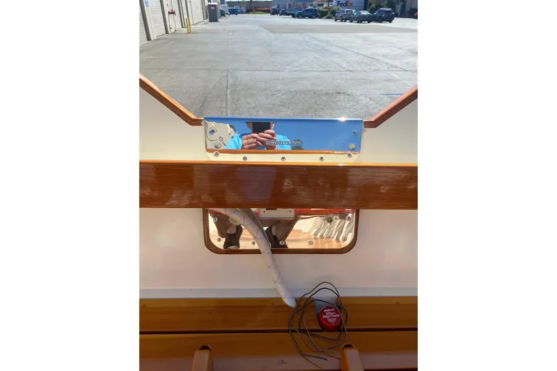 Slide: The Image of Interior view of a 1996 Custom Don boat with polished wood and reflective surfaces. - 7