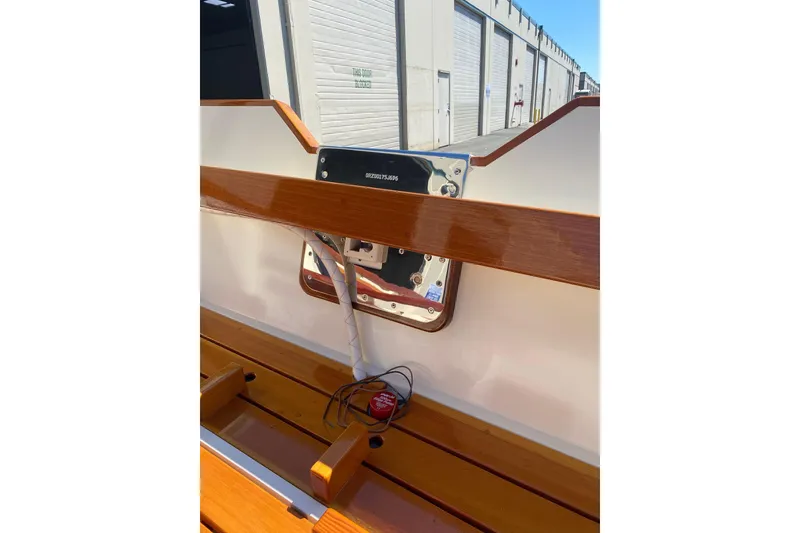 Slide: The Image of Wooden interior of a 1996 Custom Don boat, featuring polished finish and wiring details. - 8