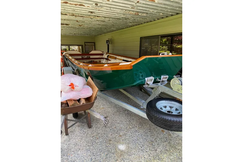 Slide: The Image of Green custom boat "Don" 1996 on trailer under a corrugated metal roof. - 9