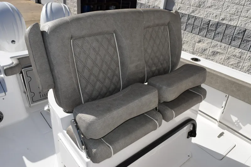 Slide: The Image of 2026 Sea Hunt Gamefish 25 boat seating with gray upholstery and diamond stitching. - 10
