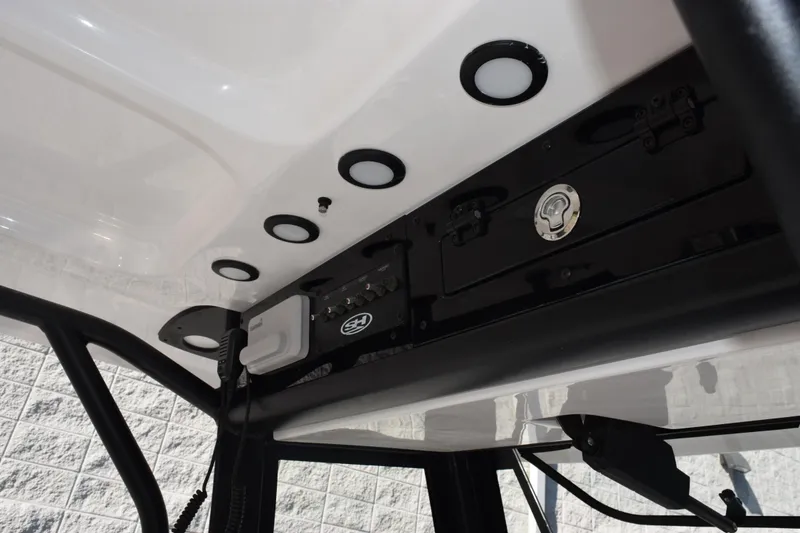 Slide: The Image of 2026 Sea Hunt Gamefish 25 boat console with storage and electronic controls. - 11