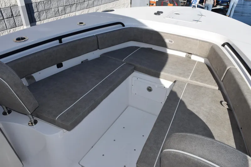 Slide: The Image of 2026 Sea Hunt Gamefish 25 boat interior with gray cushioned seating. - 12