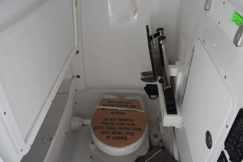 Slide: The Image of Interior of 2026 Sea Hunt Gamefish 25 boat with protective film on toilet. - 16