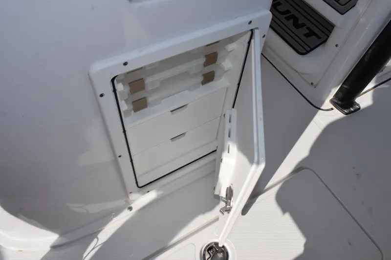 Slide: The Image of Open storage compartment on 2026 Sea Hunt Gamefish 25 boat deck. - 23