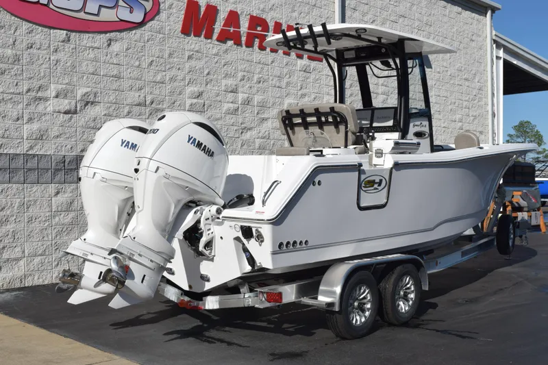 Slide: The Image of 2026 Sea Hunt Gamefish 25 boat with twin Yamaha engines on a trailer. - 4