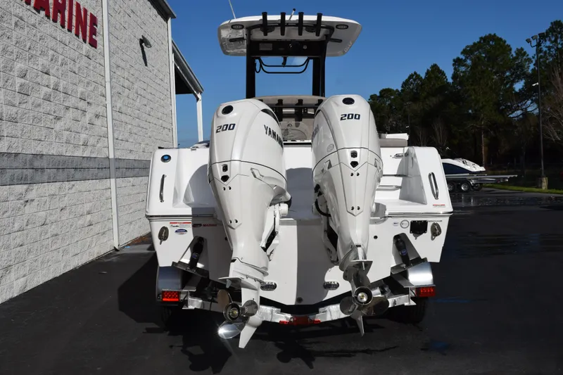Slide: The Image of 2026 Sea Hunt Gamefish 25 with dual Yamaha 200 engines, parked outdoors. - 5