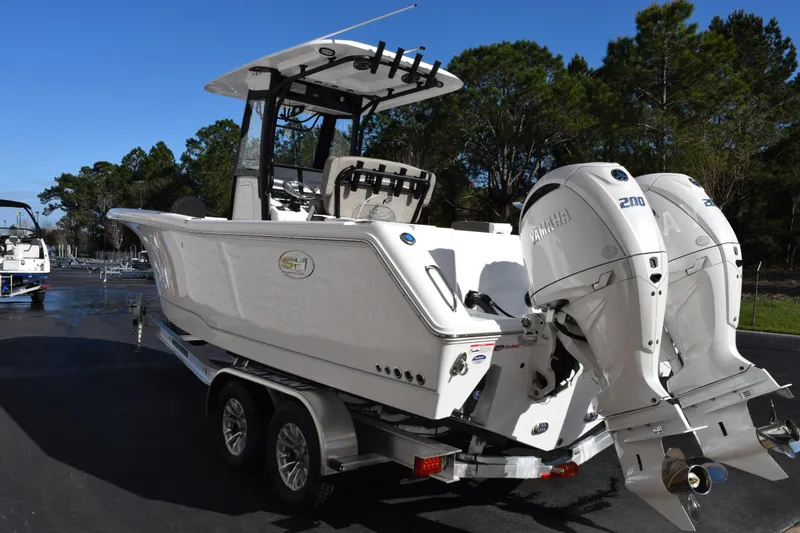 Slide: The Image of 2026 Sea Hunt Gamefish 25 boat with dual Yamaha 200 engines on a trailer. - 6